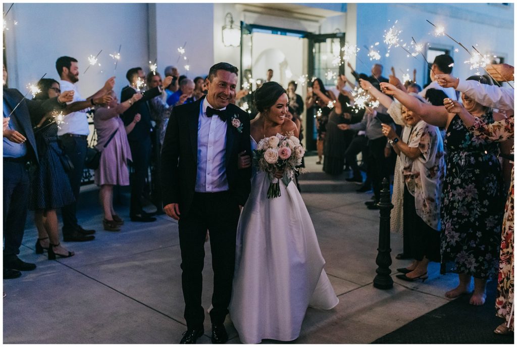 bride and groom during sparkler exit during european chic wedding