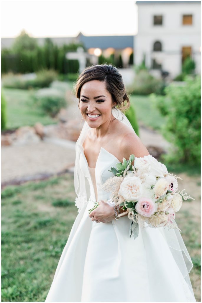 bride laughing during outdoor bridals in gardens 