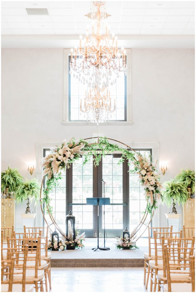 ceremony arch with elegant gold touches and greenery