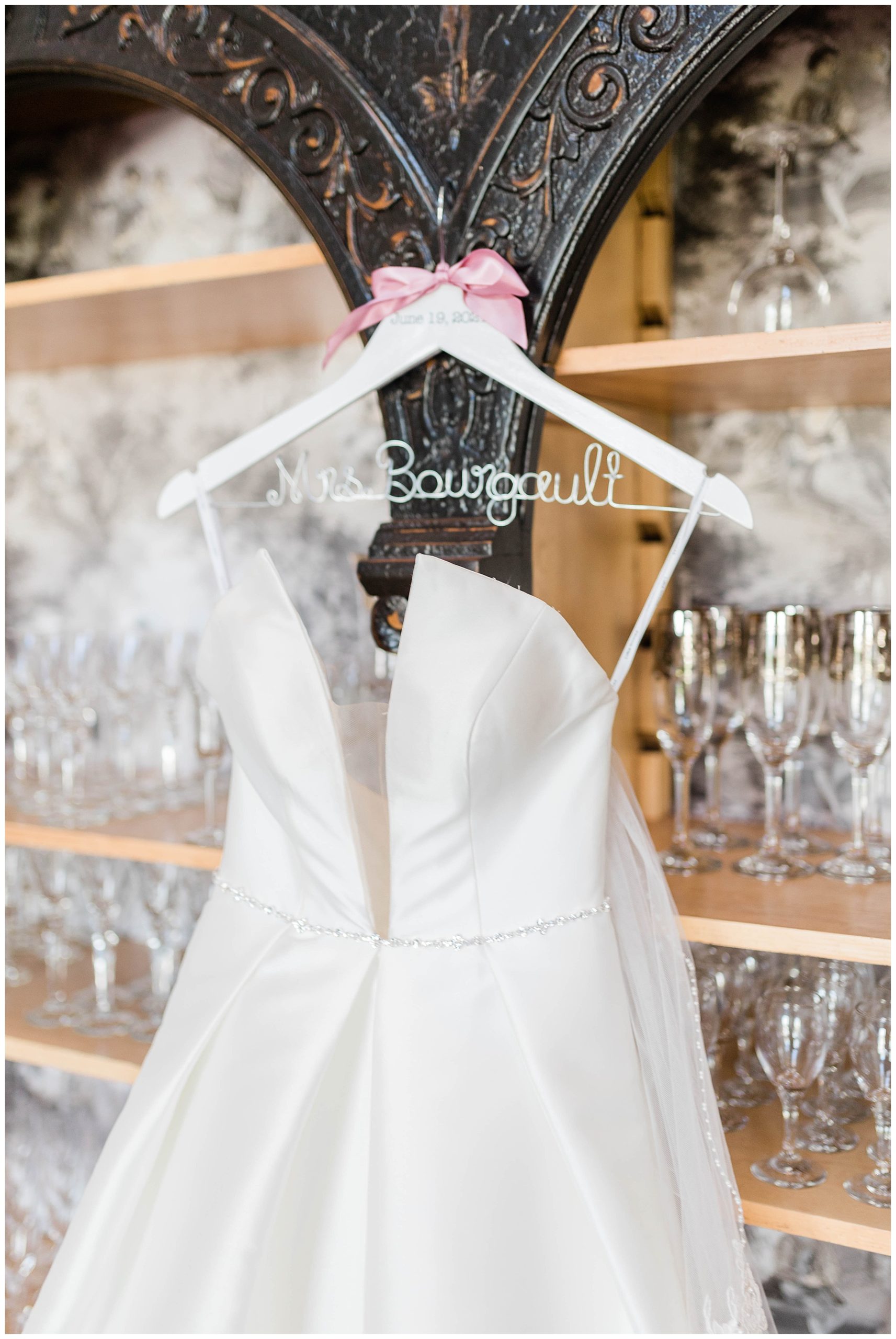 strapless bridal gown hanging on 'mrs' hanger at european chic wedding event