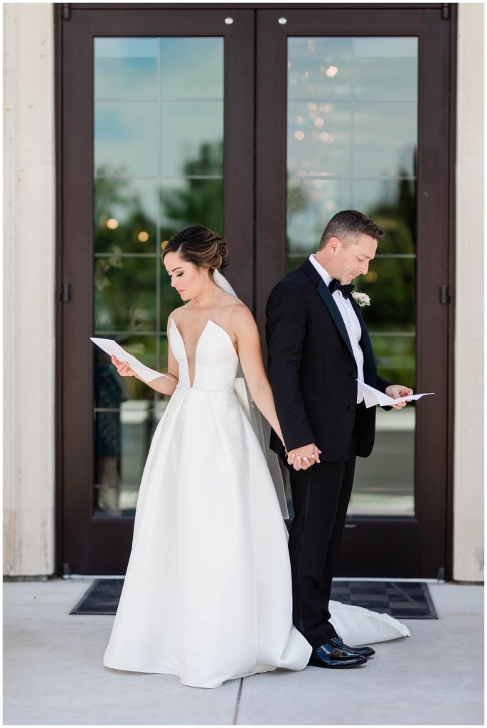 bride and groom reading romantic letters written to one another on wedding day