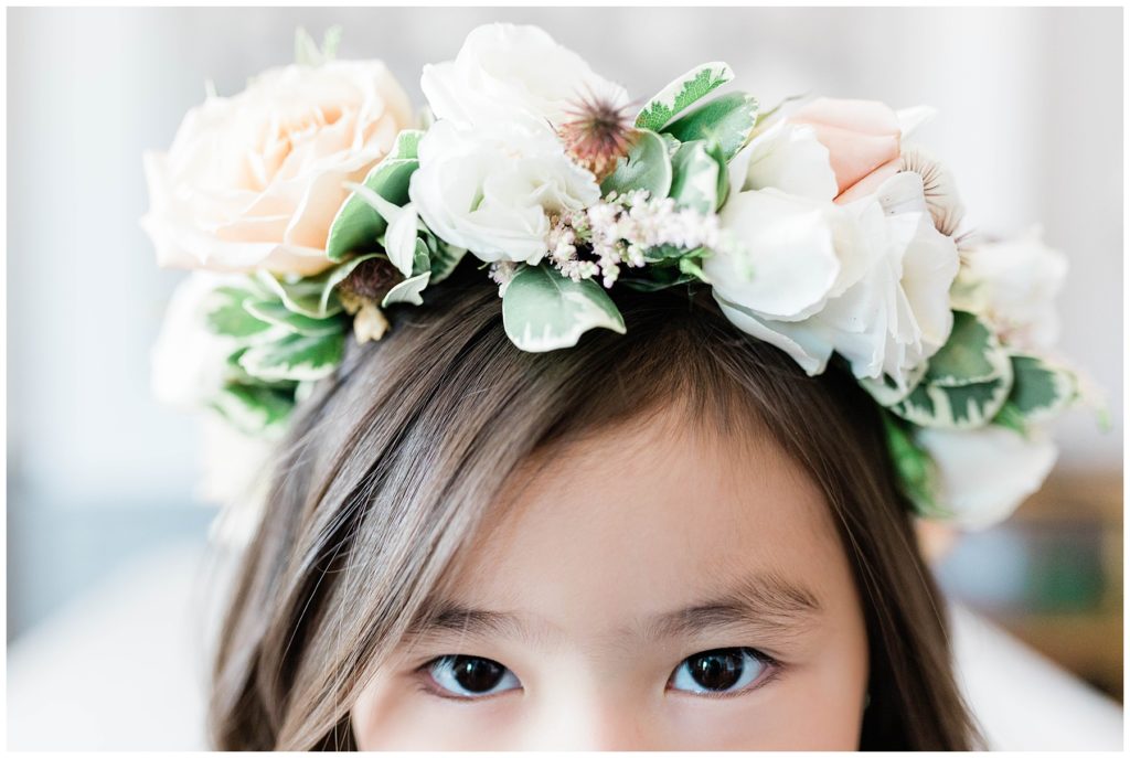 flower girl wearing floral crown with white and pink florals