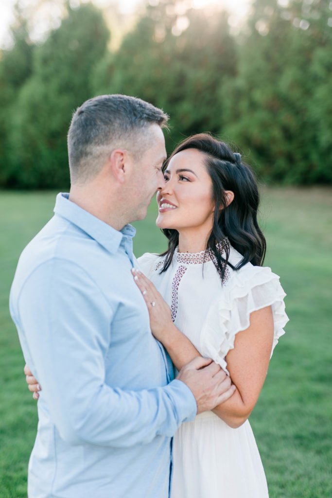 couple hugging nose to nose during outdoor engagement session