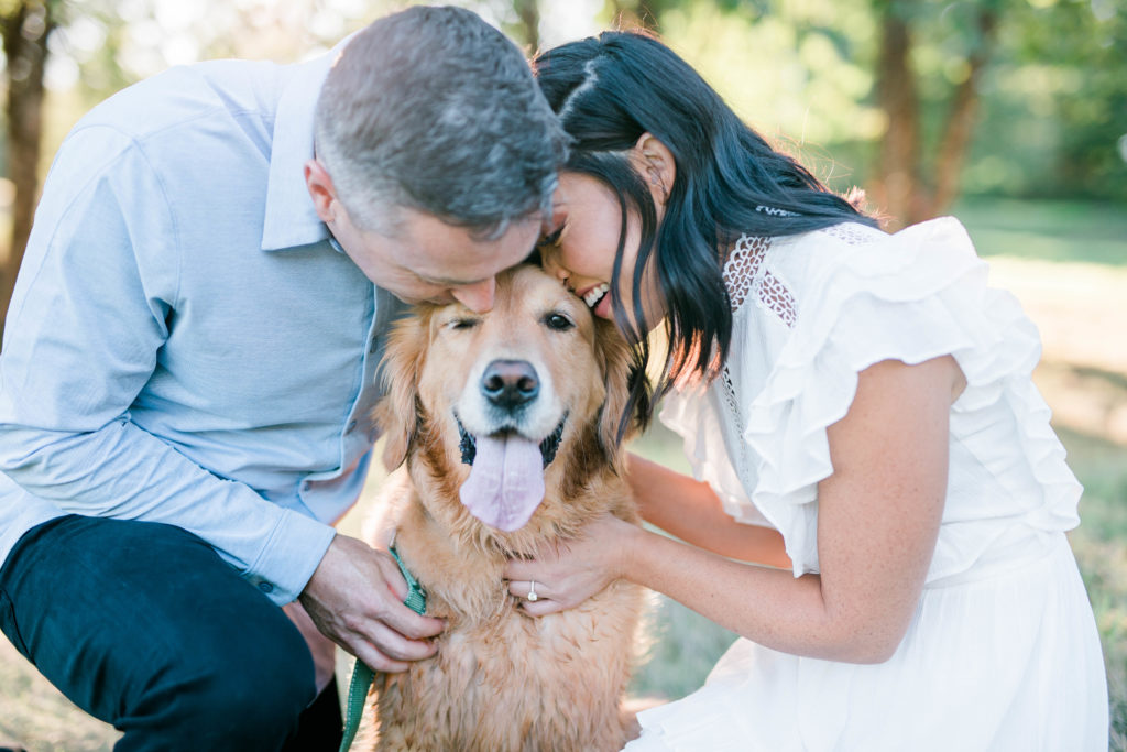 Boise wedding photographer captures couple kissing dog during outdoor engagement session