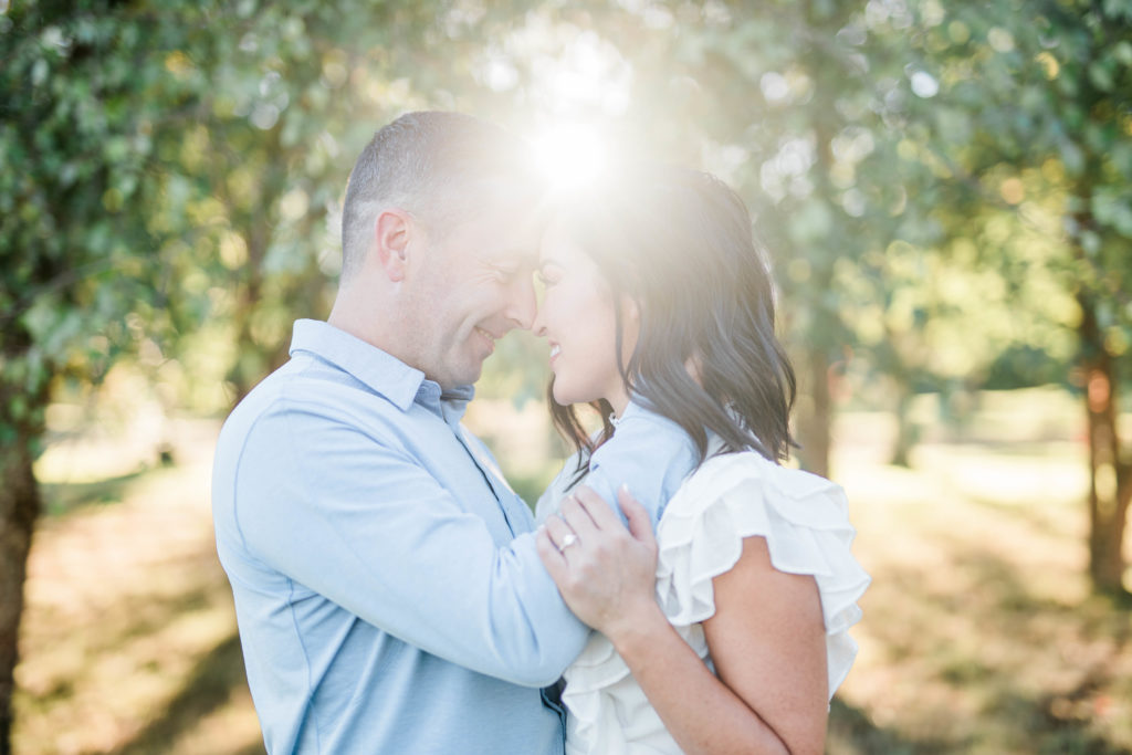 engaged couple nose to nose during golden hour photos
