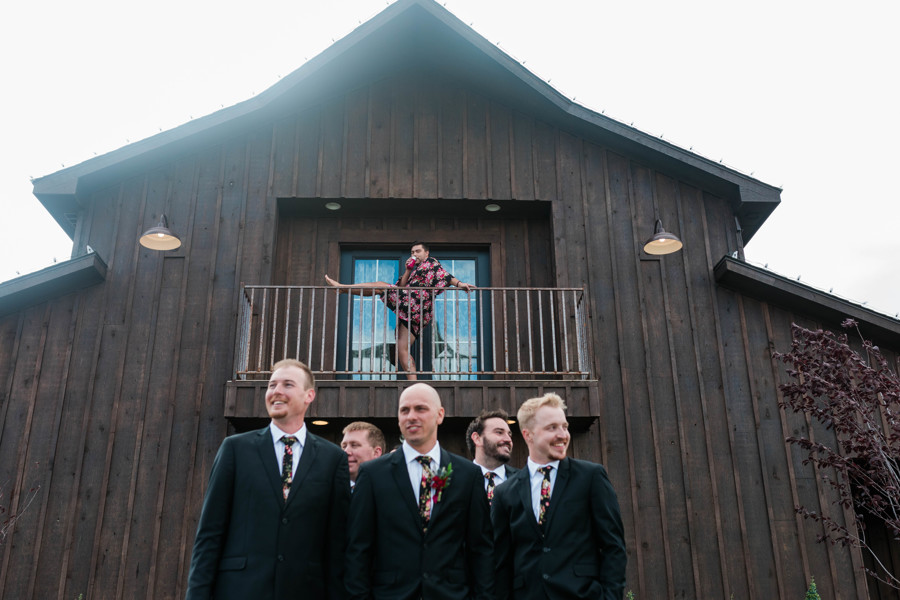 groomsmen during bridal party portraits and bridesman crashing portraits in background