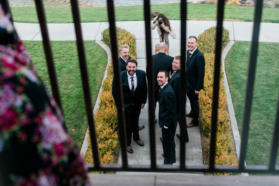 groomsmen seeing bridesman playing with them and laughing