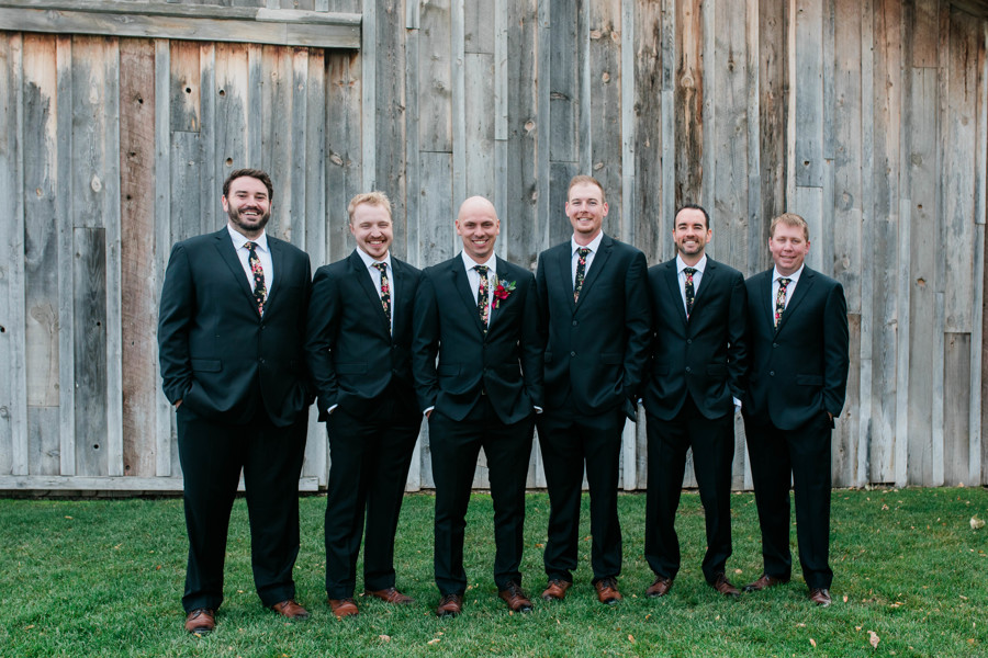 groom standing with his groomsmen during outdoor bridal portraits