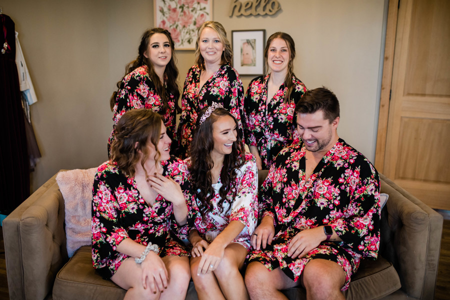 Liz with bridal party in matching floral robes getting ready on wedding day