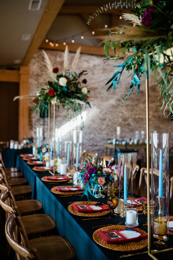 elegant and tall wedding centerpieces with greenery and gold throughout