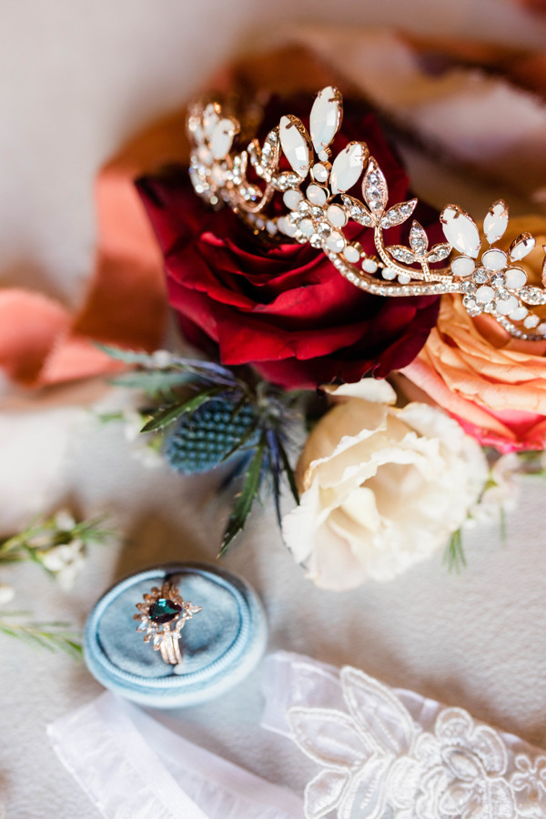 bridal detail shots of crown, red and orange florals and ring during whimsical still water hollow wedding