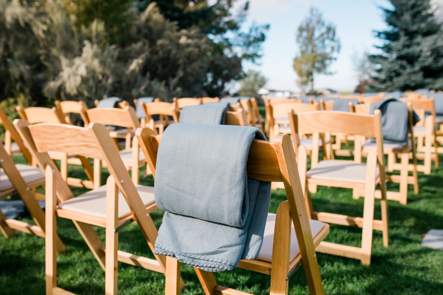 wooden lawn chairs set up for outdoor rustic and whimsical wedding ceremony