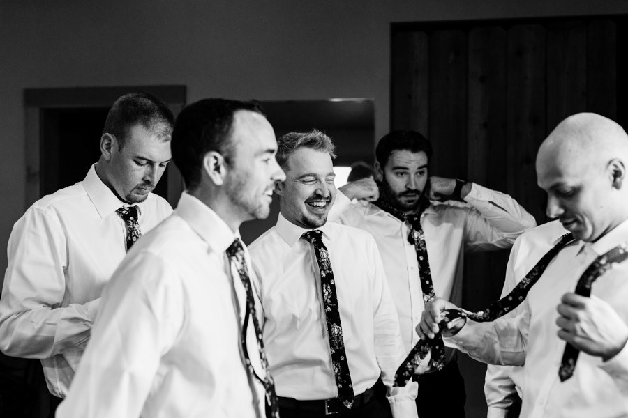 groom getting ready with friends on wedding day