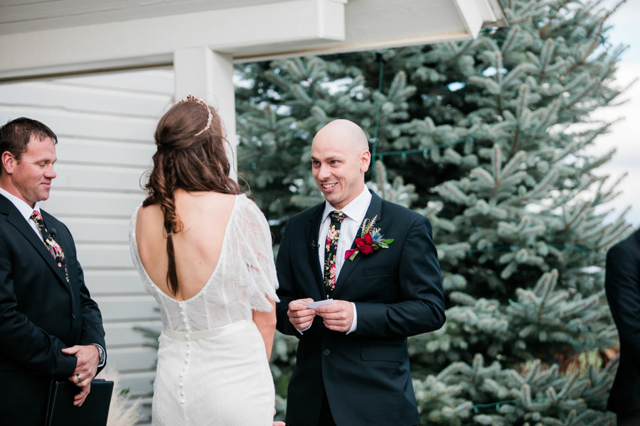 groom reading vows during whimsical wedding ceremony