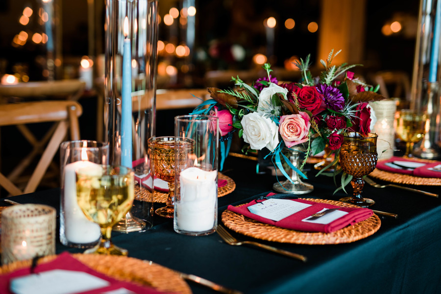 moody fall wedding reception decor with rose centerpieces and candles