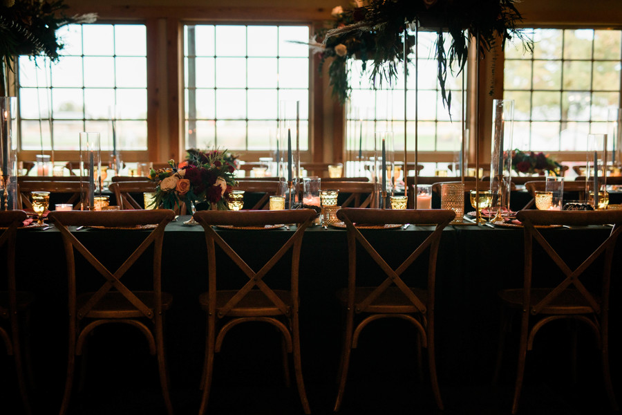 reception table set up with cozy candles and moody elements