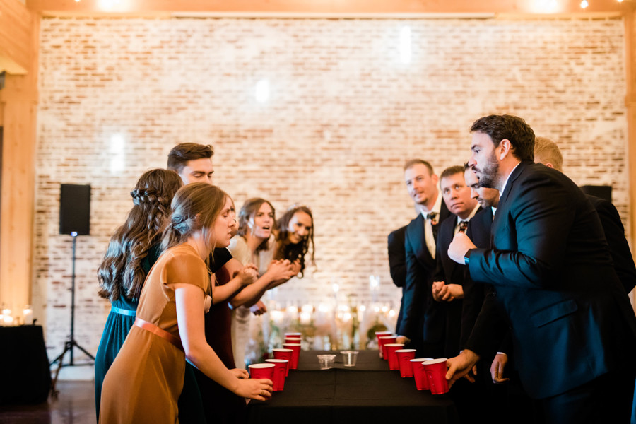 bridal party playing flip cup drinking game together