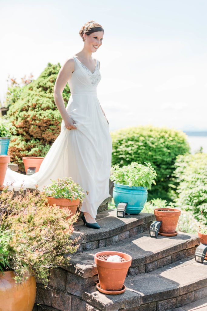 bride walking down steps in simple wedding gown