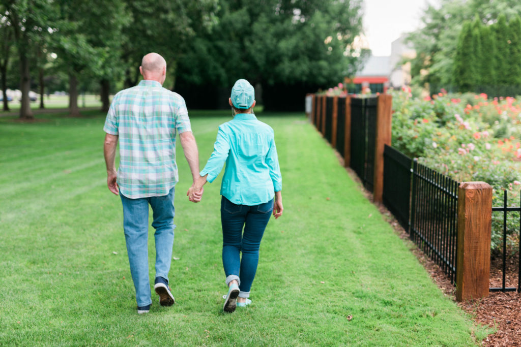 couple walking together through Rose Garden Boise 