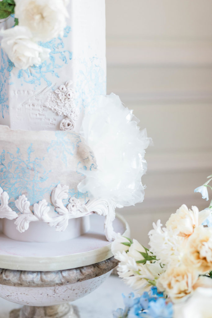 floral detail at the bottom of a pastel blue wedding cake for a destination wedding photoshoot