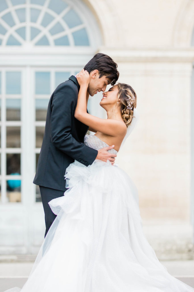 bride and groom hold each other romantically outside of their destination wedding venue 