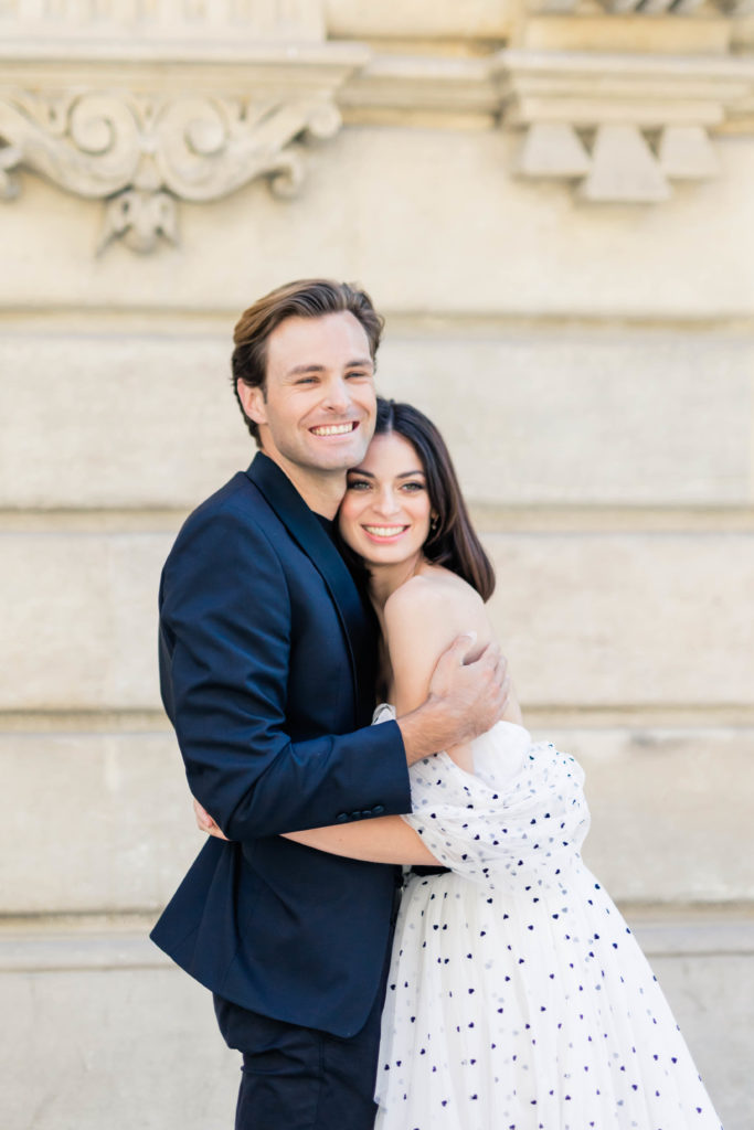man and woman huggin after their Paris France proposal 