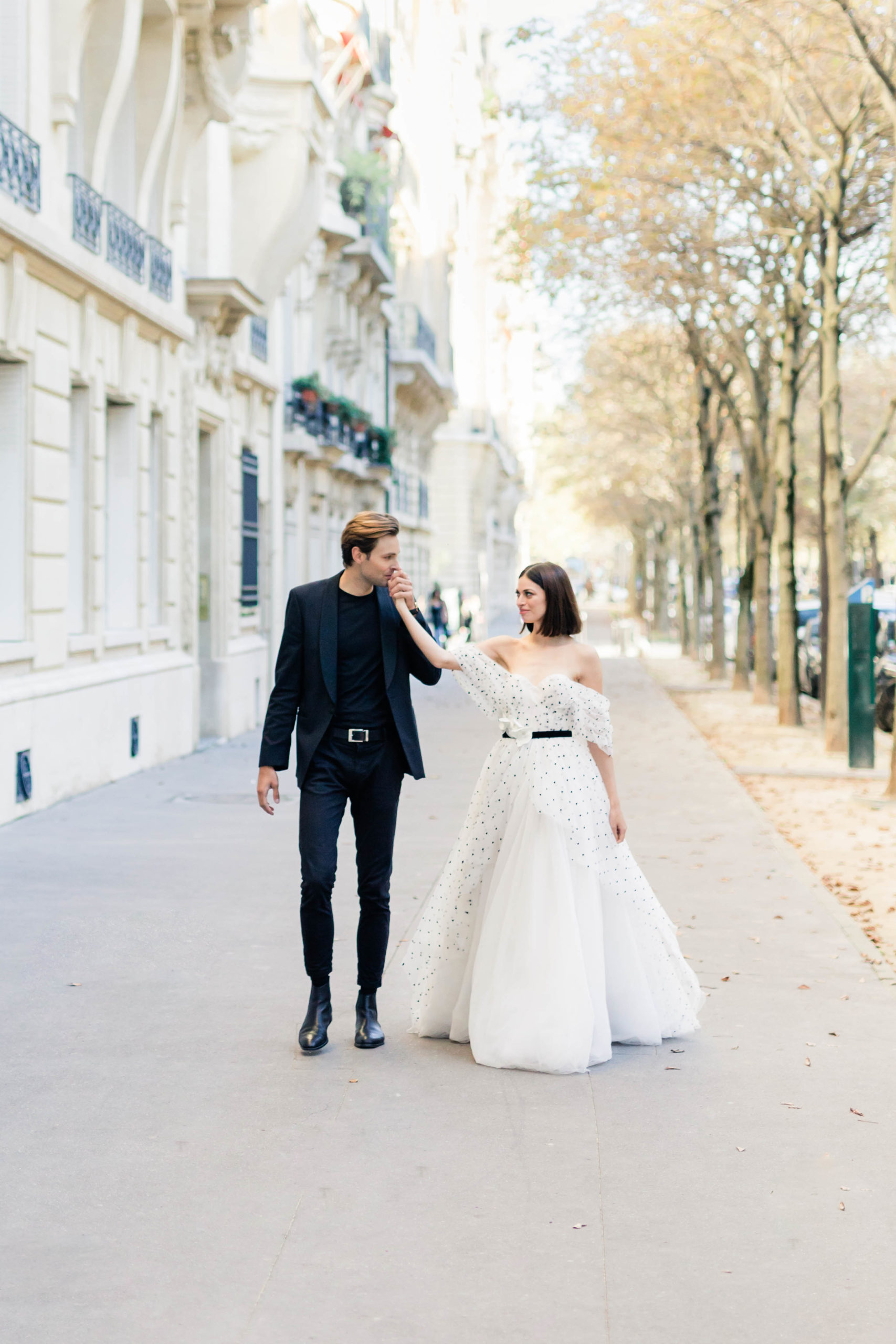 Paris France proposal session with man kissing woman hand while walking together