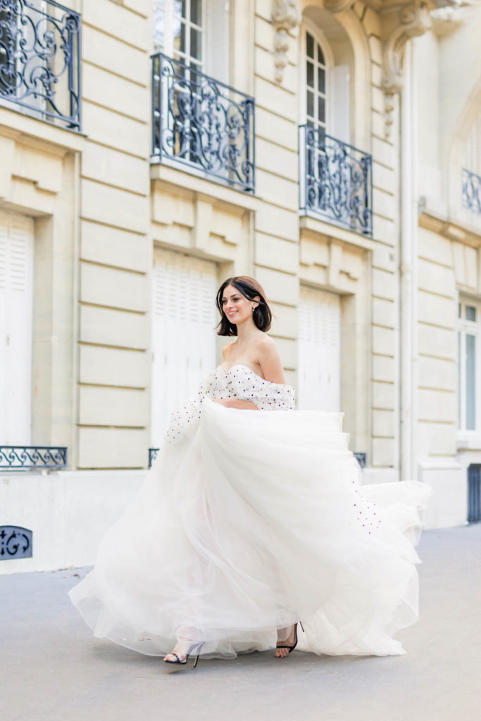 woman dancing in the streets of Paris right before her destination proposal 