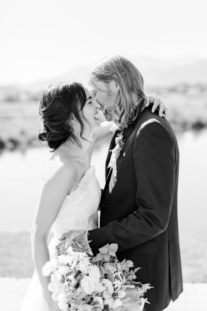 black and white wedding photos with bride and groom laughing together at their outdoor Boise wedding venue