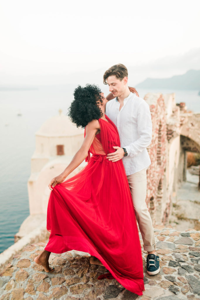 elegant engagement photo poses with man and woman dancing together in Greece for their destination engagement photos