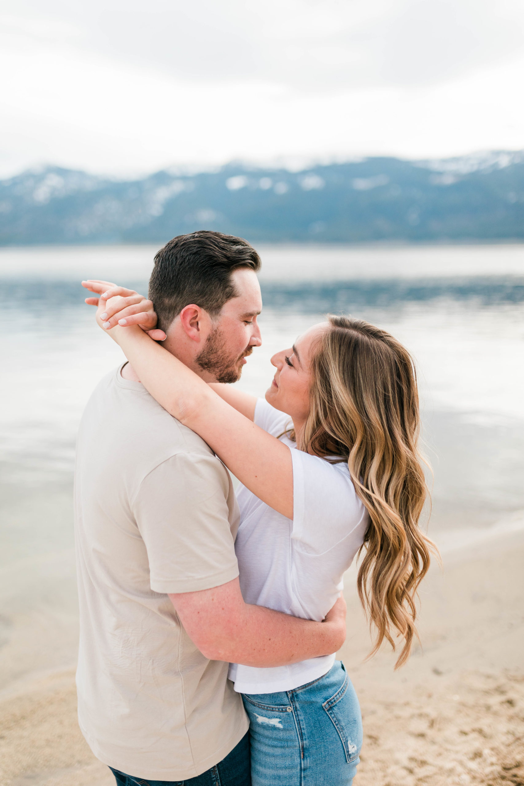 lake engagement photos with man and woman embracing each other in Boise Idaho photoshoot