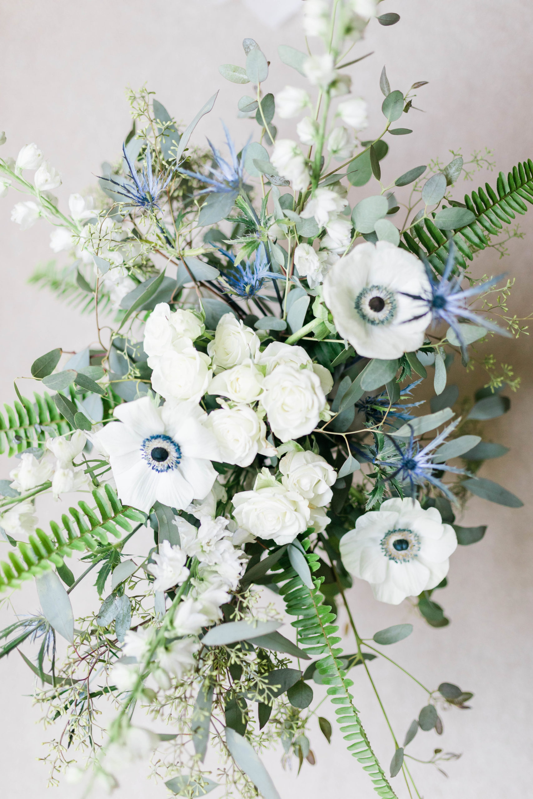 elegant bridal bouquet with white and light blue florals and greenery