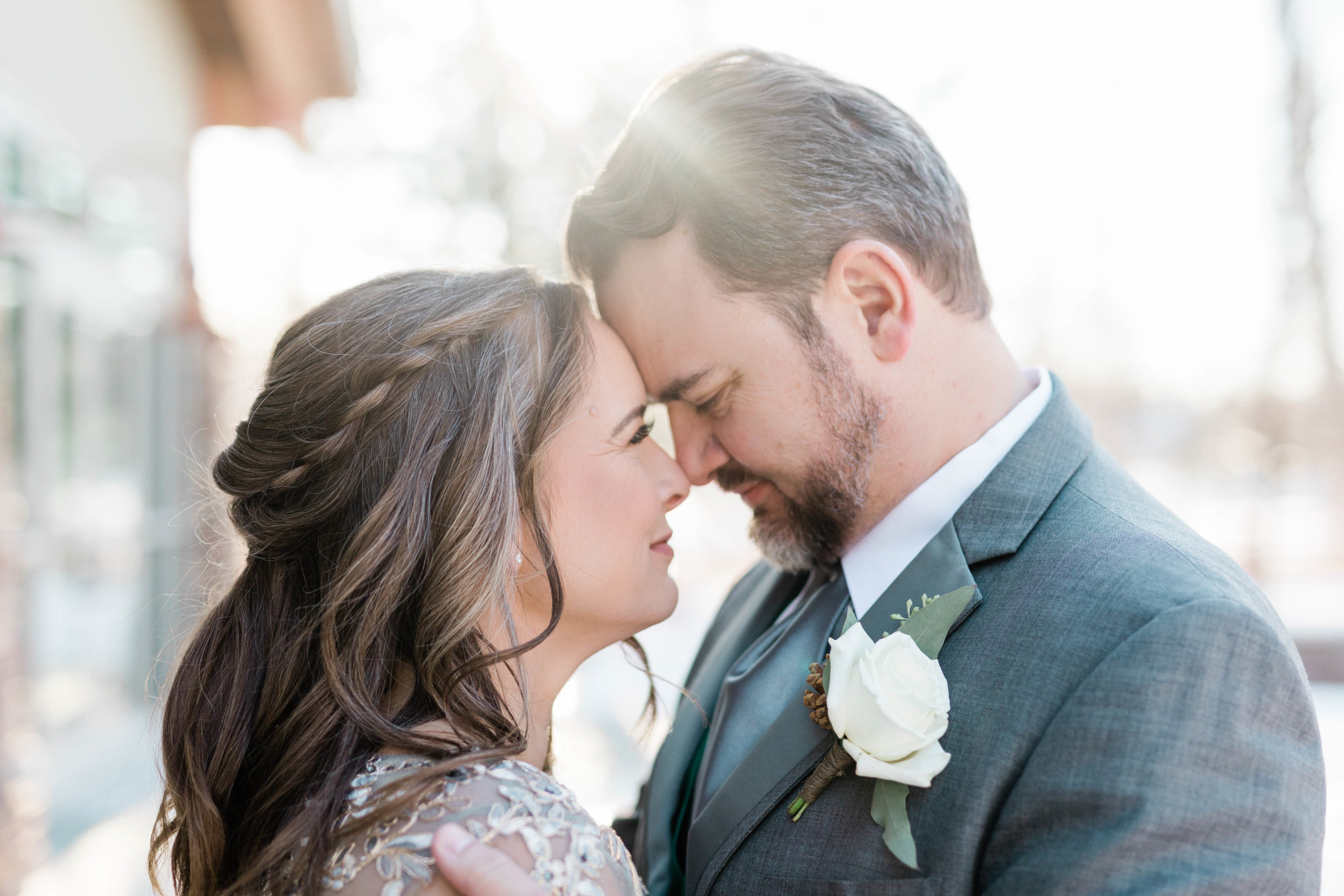 bride and groom embracing with their foreheads together and smiling as their noses touch captured by Boise wedding photographer