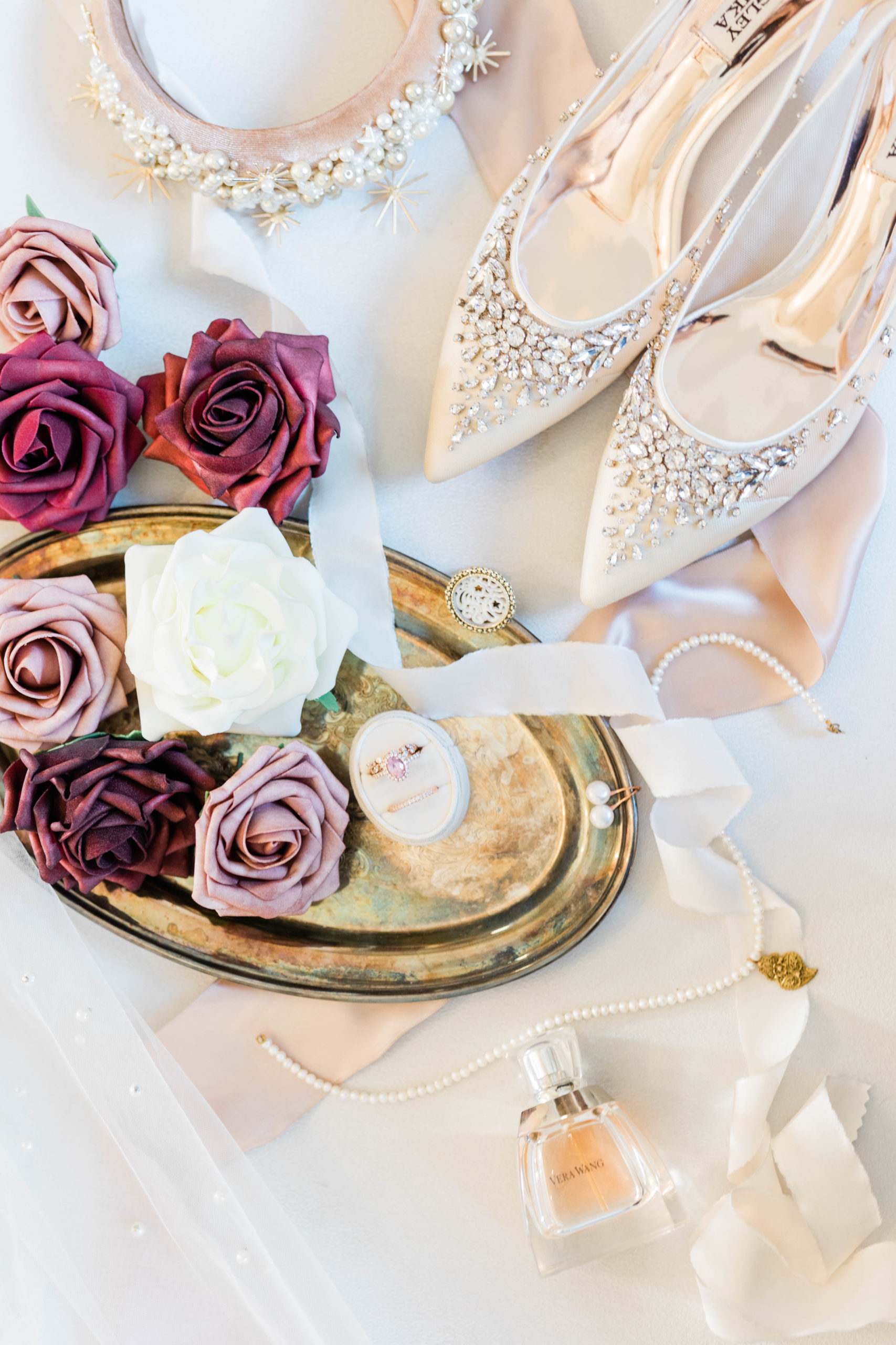 wedding details of brides shoes, wedding ring and florals 