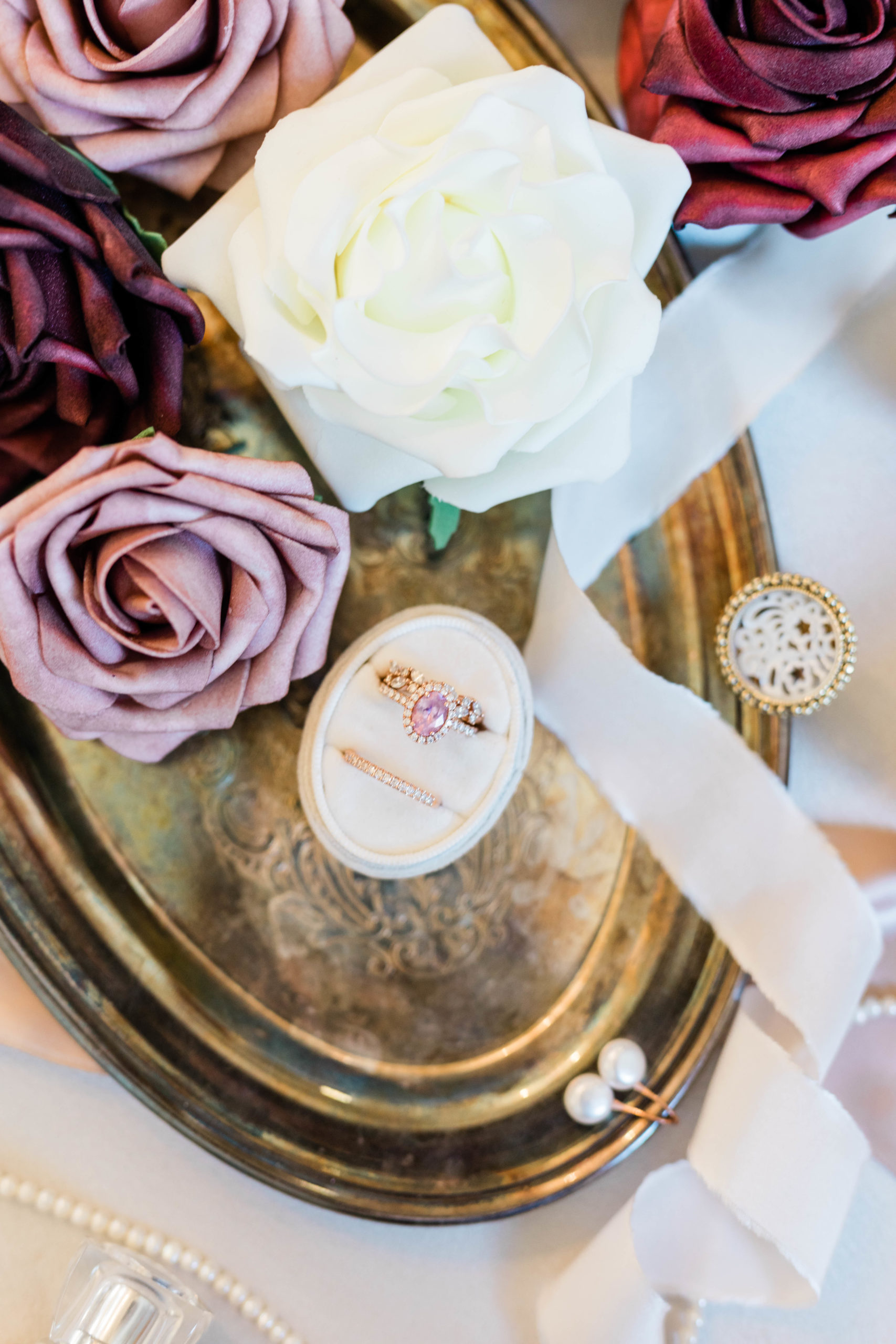 wedding ring detail shot with purple roses