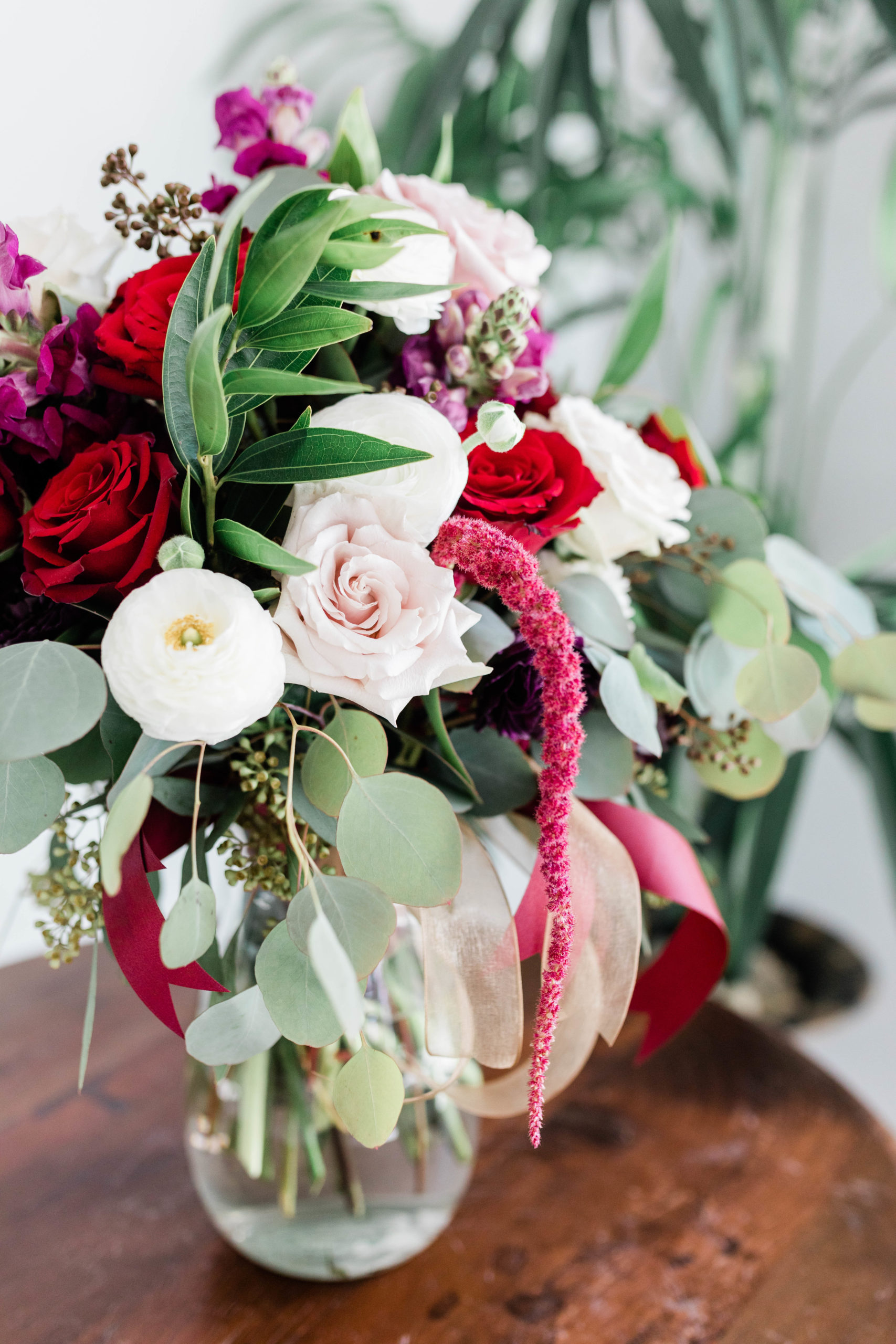 red roses and bright pink florals ina bridal bouquet at a Boise wedding