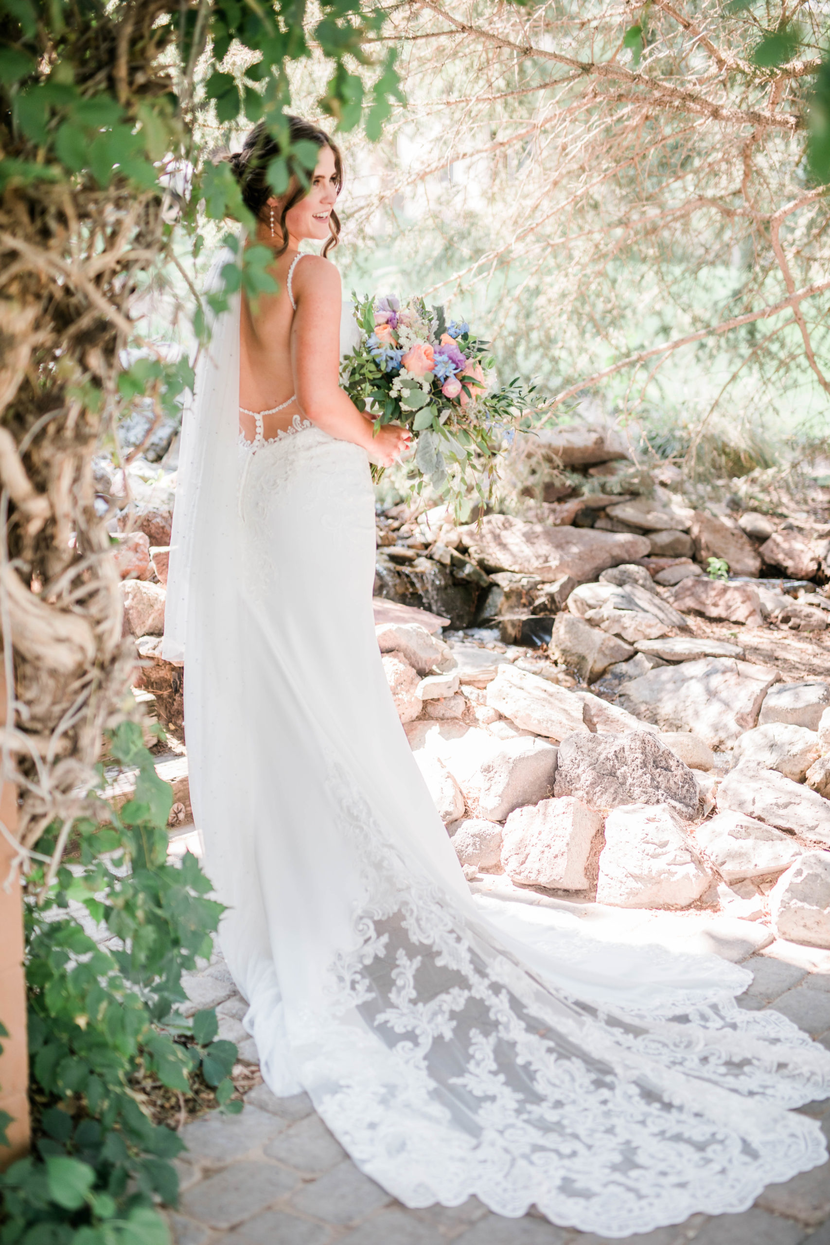 detail shot of brides lace dress in a garden in Boise wedding