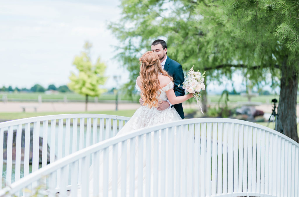 first look on a simple white bridge at Nampa wedding venue is Idaho with Boise weddin gphotographers
