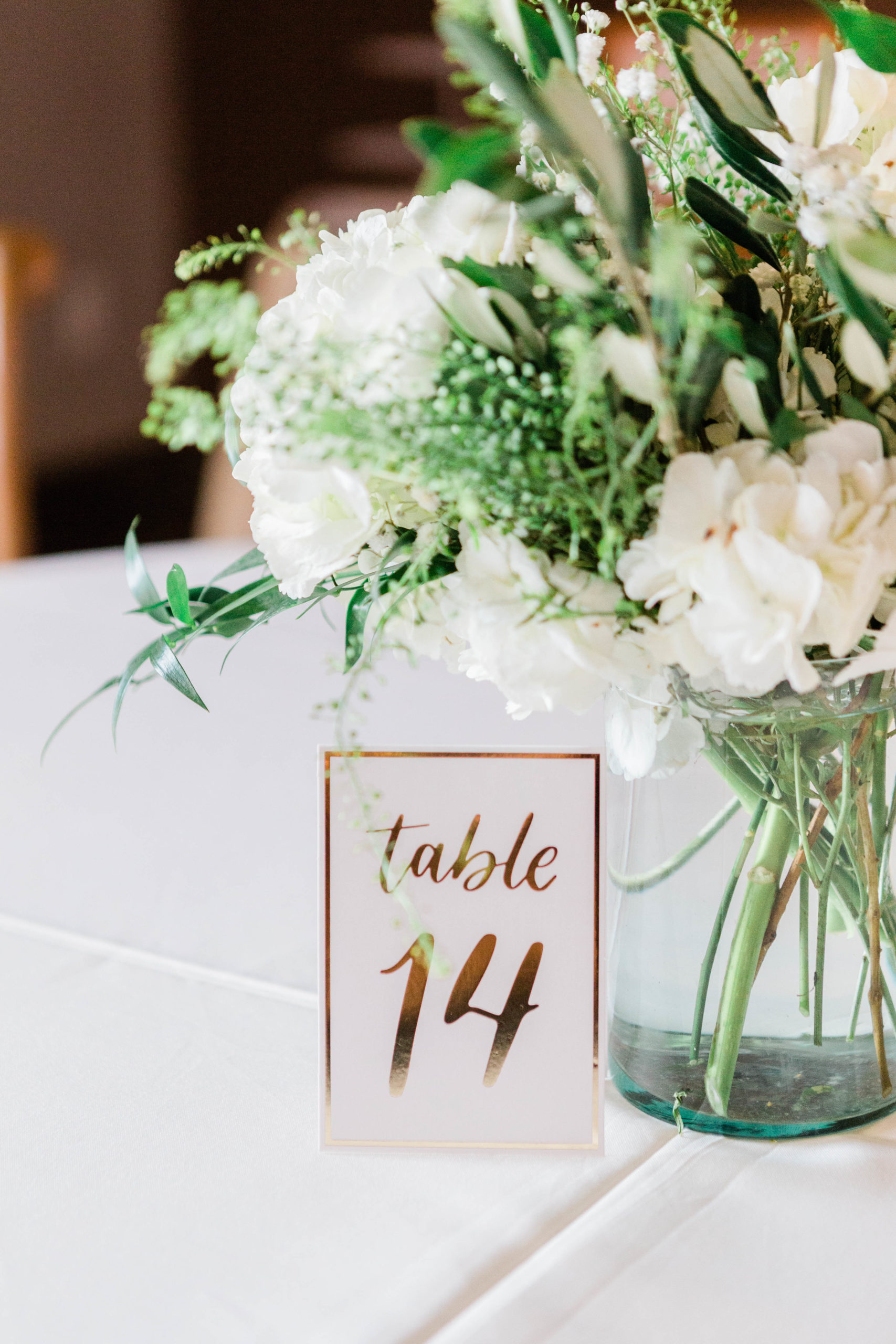 Table number and white florals for reception decor