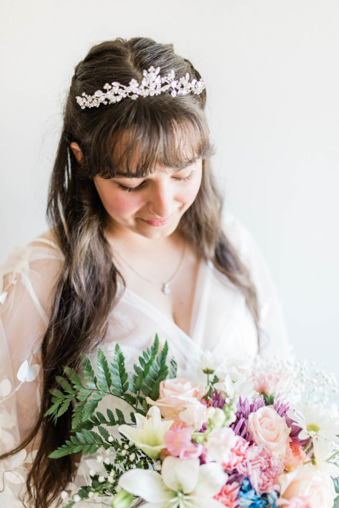Boise wedding photographer captures bride holding her wedding bouquet and smiling