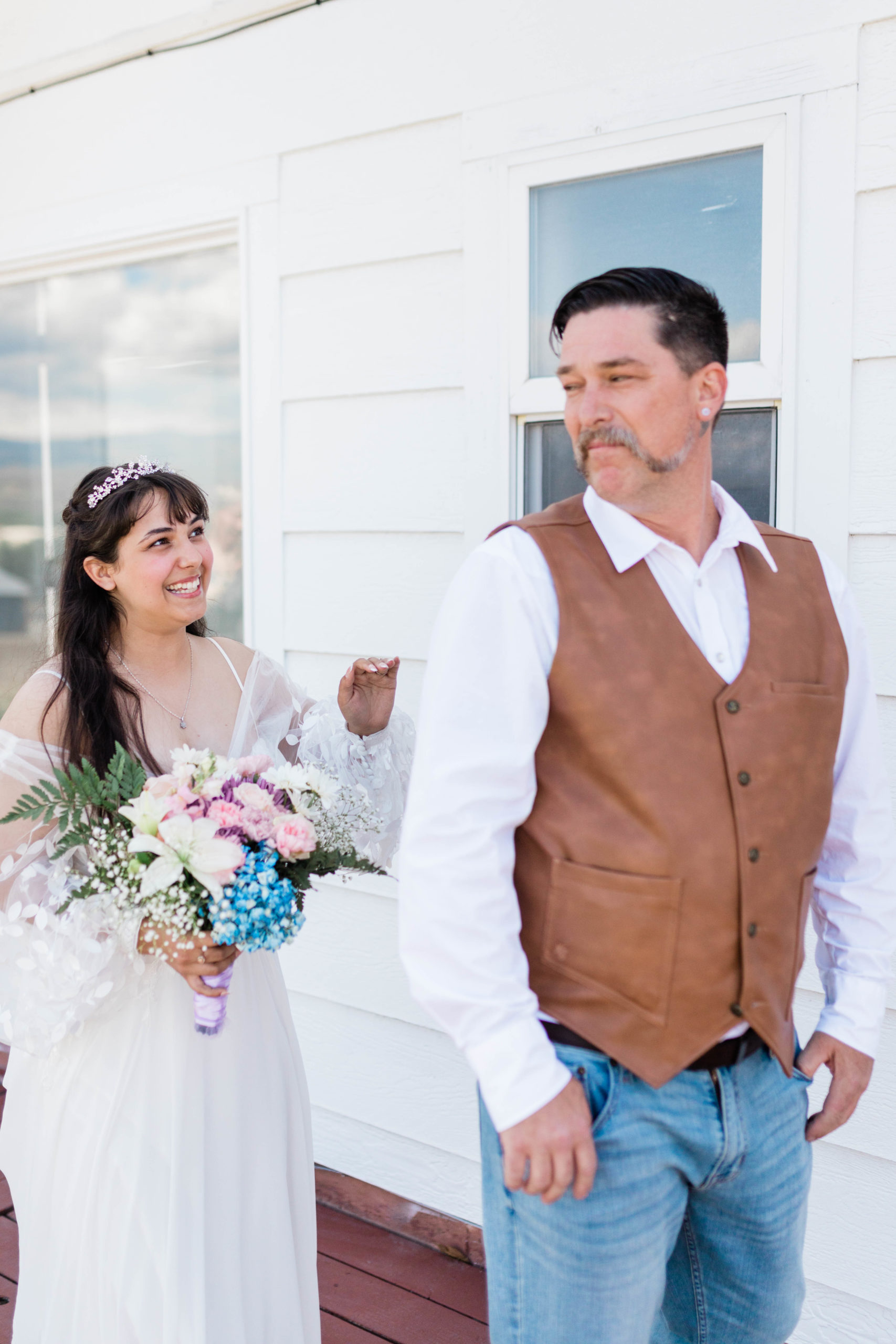 bride walking up behind her dad for a first look on her boho backyard wedding