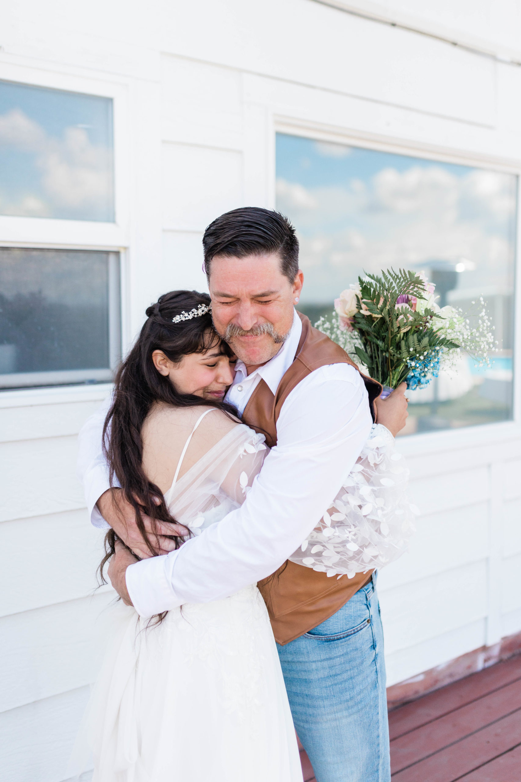 father of the bride hugging his daughter after their first look together