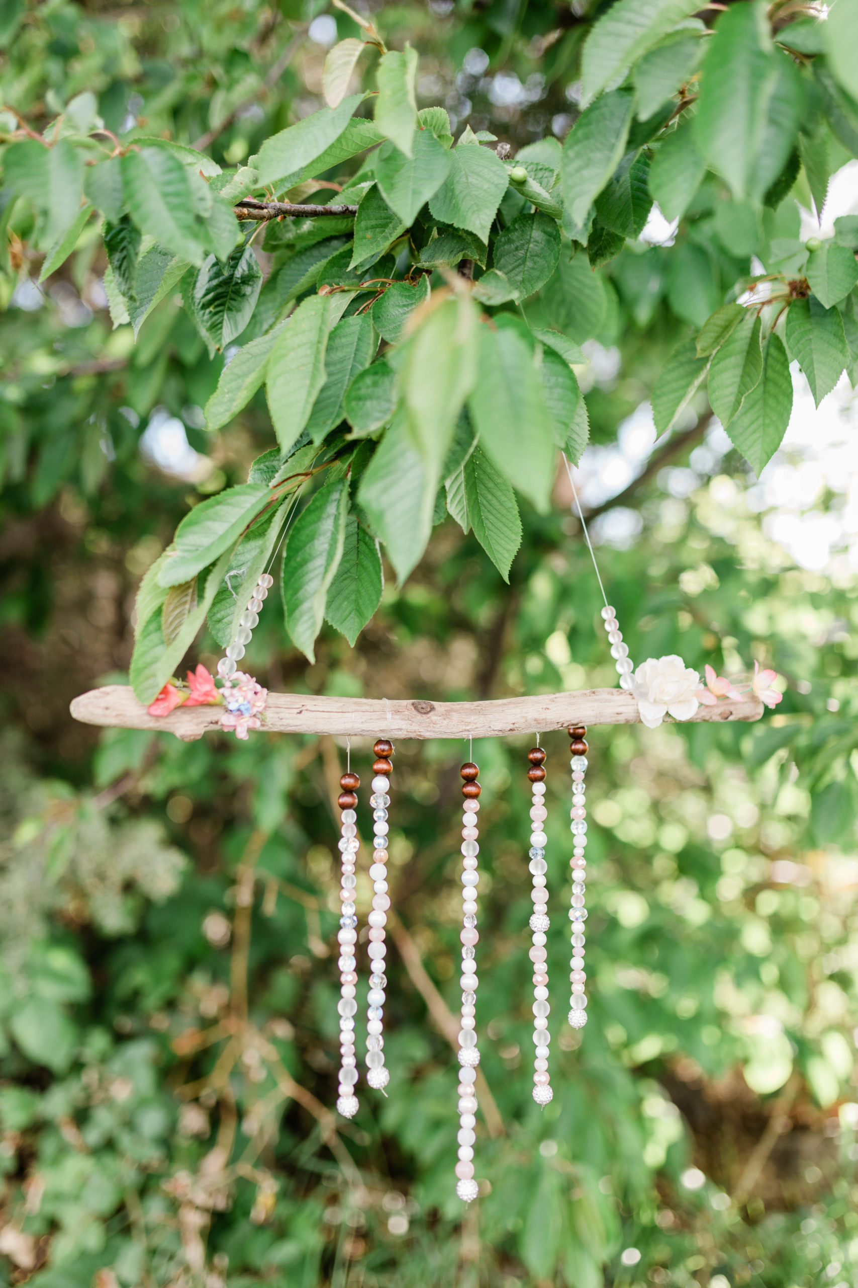 boho wedding decor hanging from a tree for an outdoor backyard wedding 