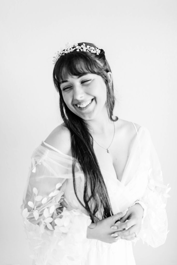black and white wedding picture of bride smiling in her boho wedding dress taken by boise wedding photographers
