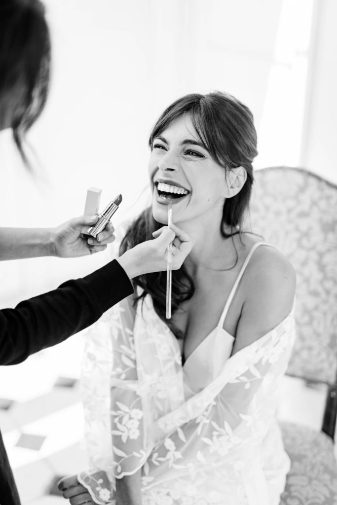 bride laughing while getting ready for wedding ceremony in Paris