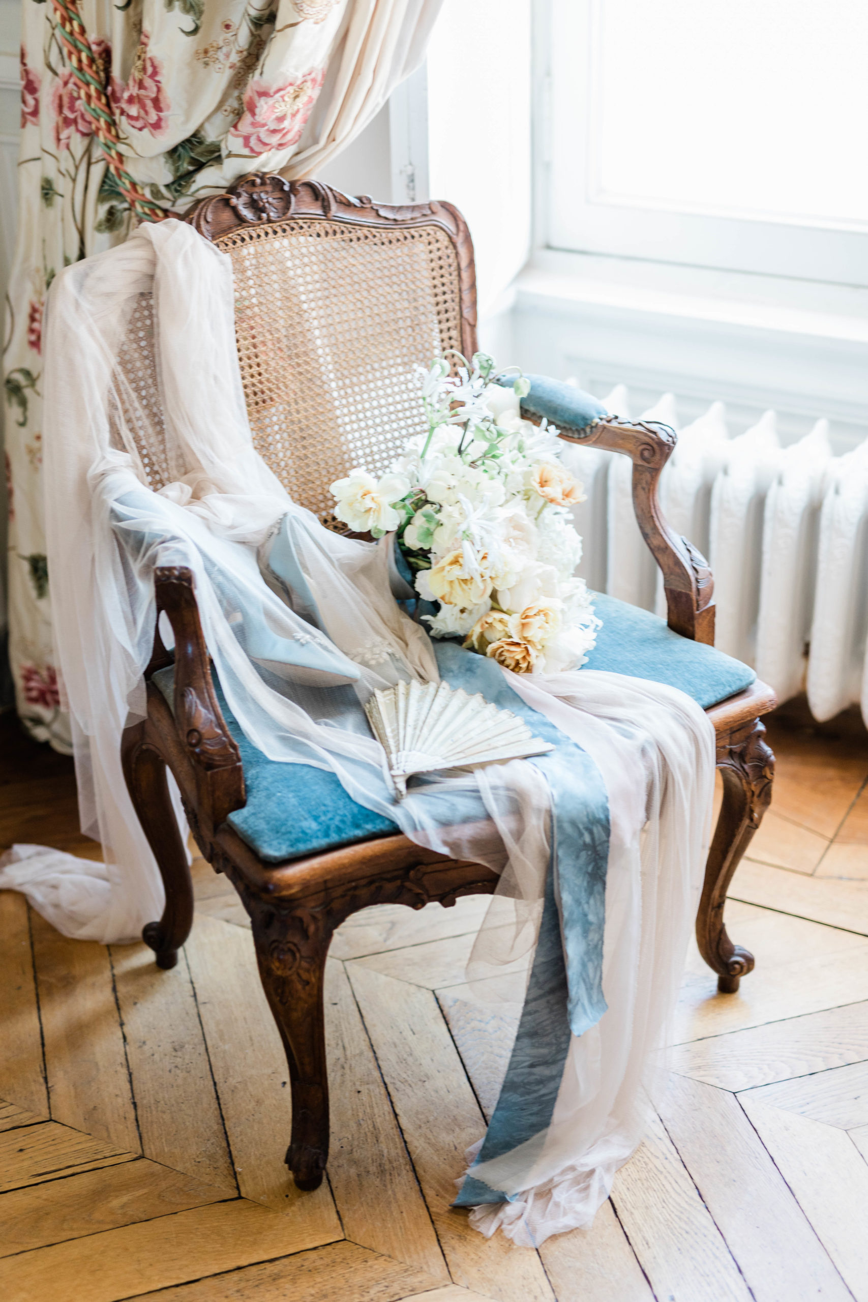 chair with veil and wedding details and florals 