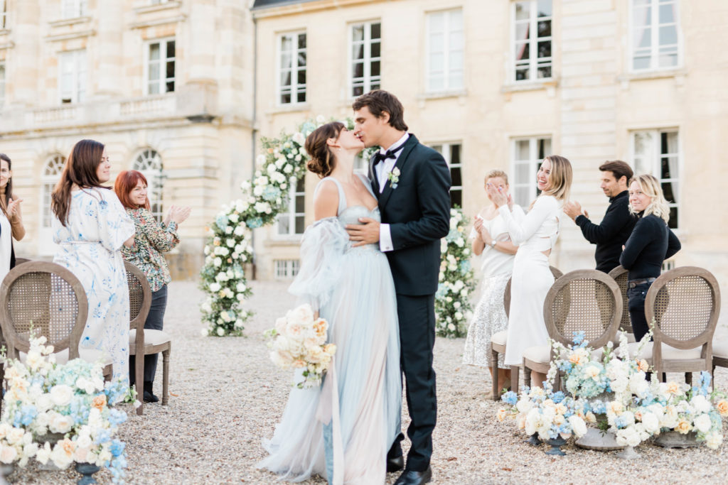 bride and groom kissing at destination in Paris after wedding ceremony