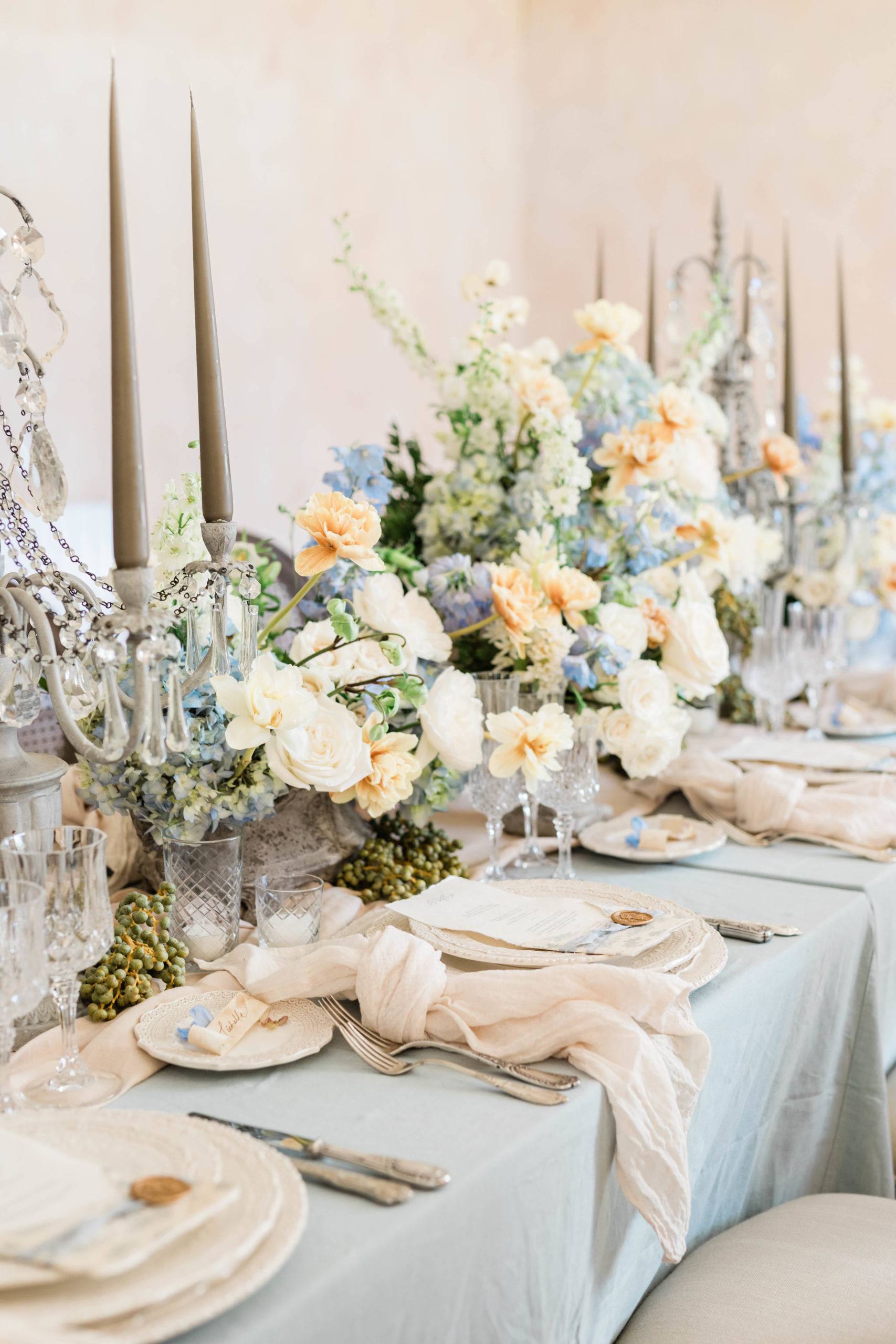 wedding table with lush pastel flroals and dusty blue details 