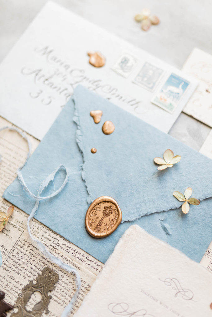 dusty blue wedding envelope for a vintage style wedding invitation with floral detail