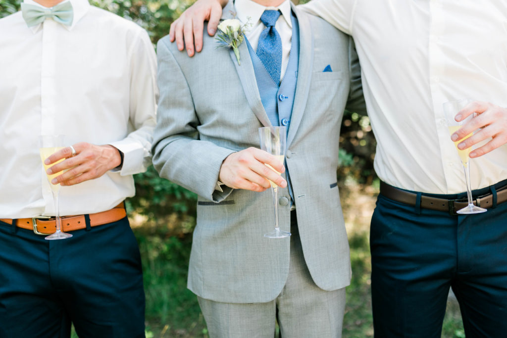 detail shot of groom holding champange before his wedding ceremony taken by Boise wedding photographer